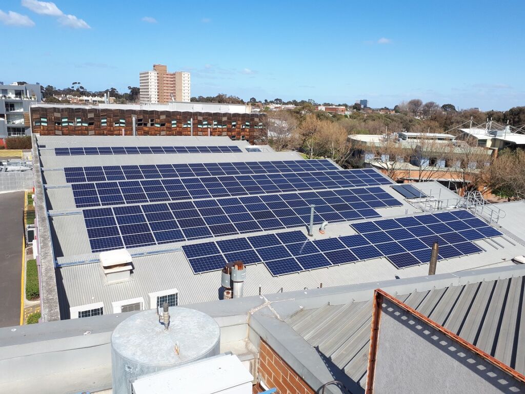 Rooftop solar panels on large university campus building